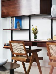 a desk with two chairs and a table with books at Walker Hotel Tribeca in New York