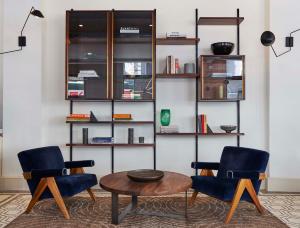a living room with two chairs and a table at Walker Hotel Tribeca in New York