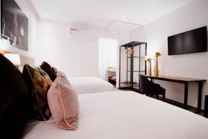 Postel nebo postele na pokoji v ubytování HOTEL MINA REAL MATEHUALA