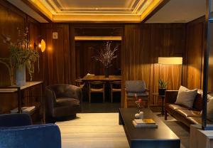 a living room with a couch and chairs and a table at Walker Hotel Tribeca in New York