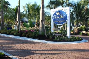 a sign for the lobby of a resort with palm trees at Casa Ybel Resort in Sanibel