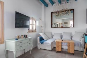 a living room with a white couch and a table at Penthouse Torre del Mar Grupo AC Gestion in Cádiz