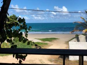 a view of the beach from a balcony at Ap Beirar Mar com Piscina in Cabo de Santo Agostinho