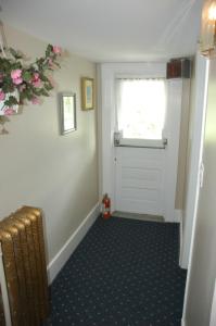 a doorway leading to a room with a door open at Windsor Guest House in Vancouver