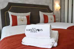 una camera d'albergo con un mucchio di asciugamani su un letto di Famous Crows Lisbon Suites a Lisbona