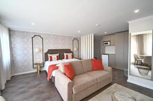a bedroom with a large bed and a large window at Famous Crows Lisbon Suites in Lisbon
