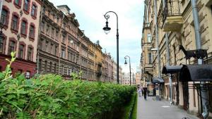 a city street with buildings and people walking down the street at Boho Home Hotel on Nevskiy in Saint Petersburg