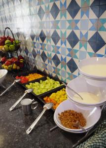 a kitchen counter filled with bowls of food and utensils at Hotel Catedral La Paz in La Paz