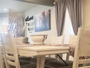 a dining room with a table and chairs at Peak Valley Manor, a Modern Farmhouse in Colorado Springs