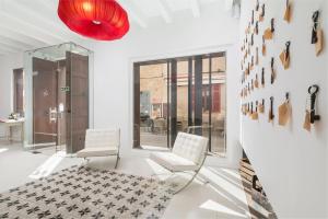 a lobby with two white chairs and a red light at Alcudia Petit - Turismo de Interior in Alcudia
