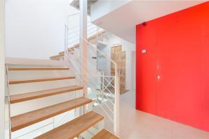a staircase with a red door and a red wall at Alcudia Petit - Turismo de Interior in Alcudia