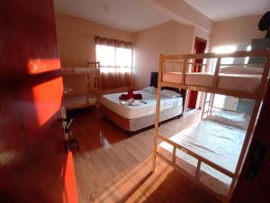 a bedroom with a bed and a bunk bed at Hostel Aeroporto in Guarulhos