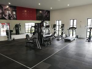 a gym with several treadmills and exercise bikes at Casa las Alas de San Miguel in San Miguel de Allende
