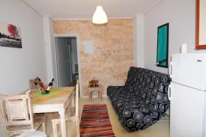 a kitchen with a table and a chair and a refrigerator at Orizontes Suites A in Kalamos