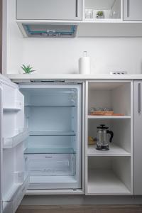 an empty refrigerator with its door open in a kitchen at Beys Palace apartments Sarajevo in Sarajevo