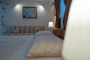 a bedroom with a bed and a couch and a mirror at Studio Banovac in Dubrovnik