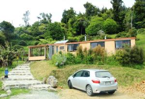 un'auto parcheggiata di fronte a una casa di Earthbridge a Hikutaia