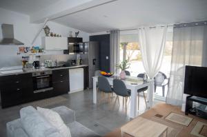 a kitchen and living room with a table and chairs at Gite Kalinka in Valensole