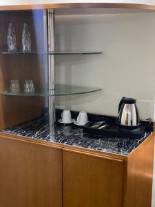 a glass counter top in a kitchen with a stove at Doolve Hotel Al Khobar in Al Khobar