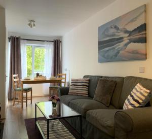 a living room with a couch and a table at Serviced Apartment Bristol One-Bedroom Southmead Hospital MOD Airbus in Bristol