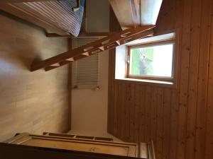 a staircase in a room with a window at 3,5 Zimmerferienwohnung Schwalbenäscht Rüeggisberg in Rüeggisberg