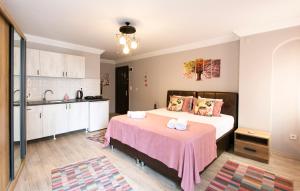 a bedroom with a large bed with a pink blanket at Sirena's Suites in Istanbul