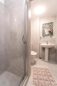 a bathroom with a shower and a toilet and a sink at Sirena's Suites in Istanbul