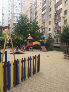 a playground with a colorful fence in a city at Красивая 2-ком.кв.,в Новом доме!От хозяйки! in Odesa
