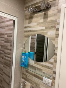 a bathroom with a mirror and a sink at Estudio Mar in Mar del Plata +14 photos