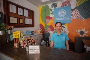 a woman standing behind a counter in a store at Island Inn in Boracay