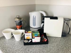 a kitchen counter with a coffee maker and some food at Thornton Lodge Motel in  Waipukurau