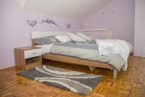 a bedroom with a bed with a rug and a table at Kuća za odmor „VILLA MARIJA” in Kostel