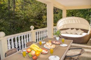 a table with fruits and drinks on a porch at Kuća za odmor „VILLA MARIJA” in Kostel