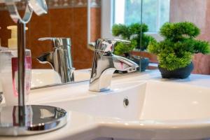 a bathroom sink with a faucet and a mirror at Kuća za odmor „VILLA MARIJA” in Kostel +45 photos