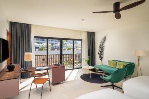 a living room with a bed and a desk at The Aviary Hotel in Siem Reap