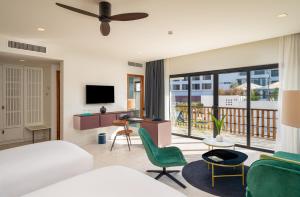 a bedroom with a bed and a living room at The Aviary Hotel in Siem Reap