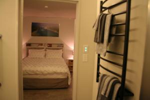 a bedroom with a bed and a bunk bed at AHAVA Bed & Breakfast in Waimate