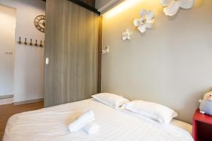 a bedroom with a large white bed with two pillows at The Loft at Midhills Genting Highlands Free WiFi in Genting Highlands