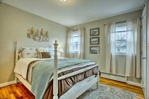 a bedroom with a bed and a window at Quaint Mystic Home about 1 Mi to Town and Masons Island in Mystic