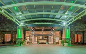a rendering of the lobby of a building with green lights at Holiday Inn Tyler - Conference Center, an IHG Hotel in Tyler