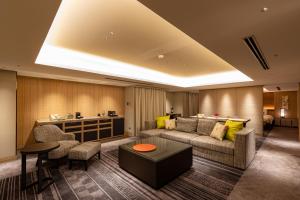 a living room with a couch and a table at Hotel Nikko Fukuoka in Fukuoka