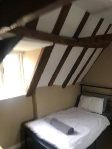 a bedroom with a bed in a attic at 18th Century Character apartment. in Ipswich