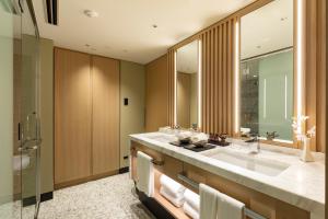 a bathroom with a large sink and a shower at Hotel Nikko Fukuoka in Fukuoka