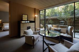 a living room with a table and chairs at Park Hyatt Kyoto in Kyoto