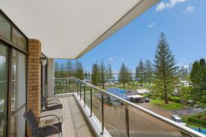 a balcony with chairs and a view of a parking lot at Tasman Towers 12 3 Munster Street in Port Macquarie