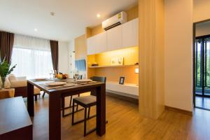 a kitchen and dining room with a table and chairs at Hill Myna Condotel in Bang Tao Beach