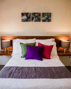a large white bed with four pillows on it at Casa MAYAHUEL x Santiago de Tequila in Tequila