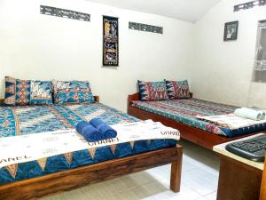 Rúm í herbergi á Ngampilan Backpacker Hostel