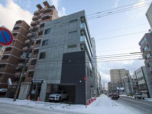 a building with a car parked in front of it at UCHI Living stay Odori 11 in Sapporo