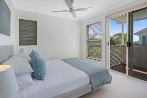 a bedroom with a bed and a large window at Privacy by the river, Noosaville in Noosaville +9 photos